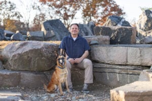 Michael Burkey and his dog Simba, a Belgian Malinois spending time together at a glacier rock park.