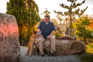Michael Burkey and his dog Simba spending time together at a glacier rock park
